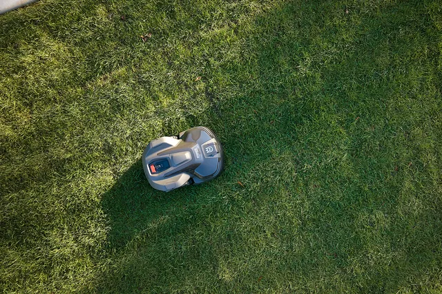 Husqvarna Automower iQ series mower operating on a lawn