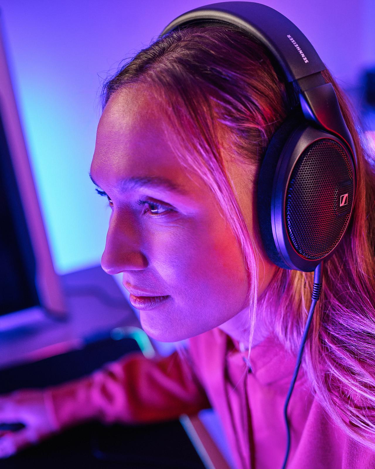 Sennheiser promotional photography of the HD 560S worn at a desk.